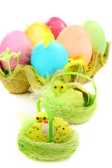 Colorful Easter eggs and chicks in a nest.