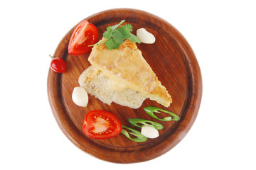 vegetable casserole piece over wooden plate