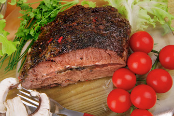 corned beef on transparent plate with salad bowl
