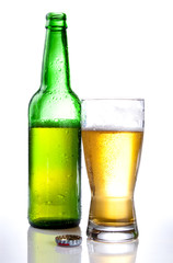 Green bottle and Half drank beer mug isolated on white backgroun