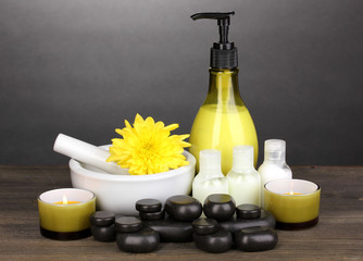 Spa setting on wooden table on grey background