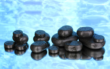 Spa stones with droplets on blue background