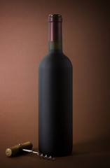 wine bottle and corkscrew on a paper background