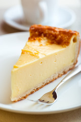 Piece of Cheesecake and Cake Fork on a Plate