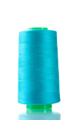 Blue bobbin thread isolated on white