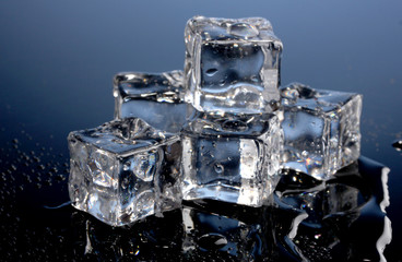 Melting ice cubes on blue background