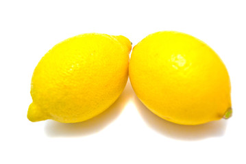 Two fresh lemons on white