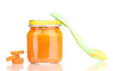 Jar of baby puree with carrot and spoon isolated on white