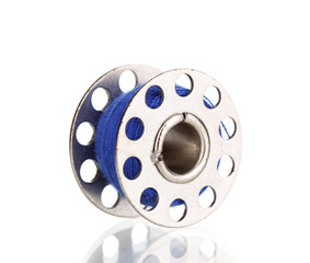 Metal spool of thread isolated on white