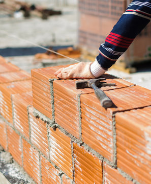 Placing bricks on bricklayer