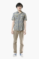 Asian young man standing isolated on white background
