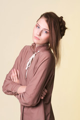 Young woman with fashion hairstyle - on beige background