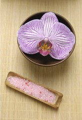 bath salt and orchid for aromatherapy on mat