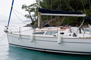 Sailing boat at anchorage in rainy morning