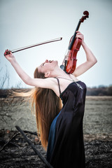 The red-haired girl with a violin outdoor