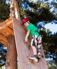 Boy climbing in adventure park