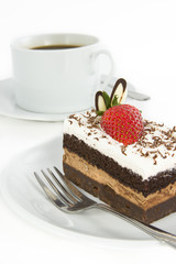 Piece of chocolate cake with strawberry decorate on top and cup