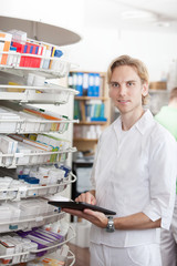 Portrait Of Male Pharmacist Holding Tablet Pc