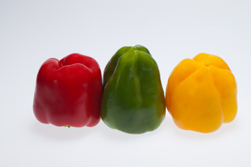 close up of red, yellow and green peppers