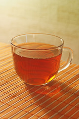 Cup of tea on a bamboo table cloth still life