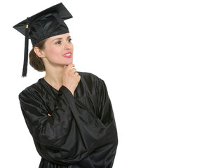 Thoughtful graduation student woman looking on copy space