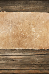 Dark grungy paper roll on a wooden background