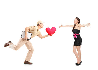 Delivery boy in a rush delivering red heart shaped pillow and ex