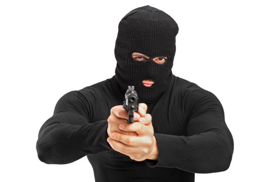 Portrait of a thief holding a gun