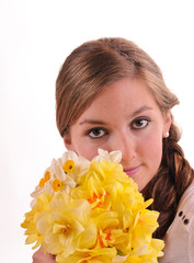 Spring: Young woman loves scented narcissus