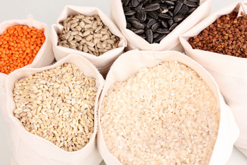 Cloth bags with grain close-up isolated on white