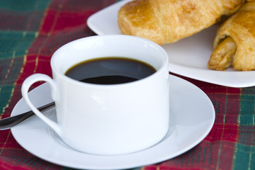 Breakfast with a cup of black coffee and croissants, Shallow DOF
