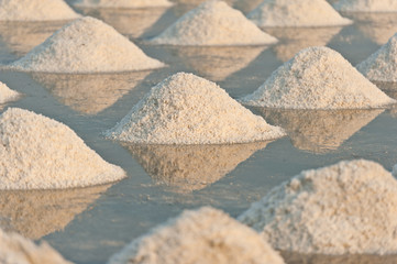 Salt fields with piled up sea salt in Thailand