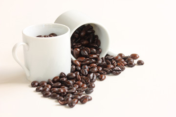Coffee beans with a white ceramic cup