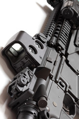 Obraz premium Modern tactical laser sght on assault carbine close-up.