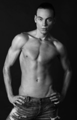 Fototapeta na wymiar Handsome young fitness sexy sportsman standing in studio