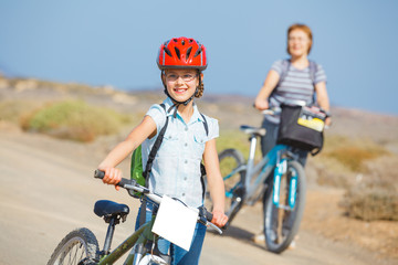 Fototapeta premium girl and her grandmother on bikes