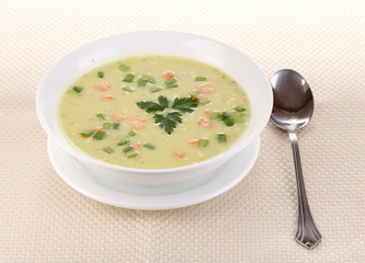 Tasty soup on beige tablecloth isolated on white