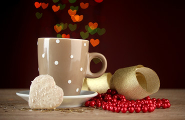 cup of coffee on wooden table on bright bokeh backdground
