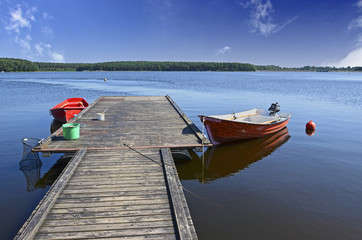 Boats moored to wooden platform on Chancza lake