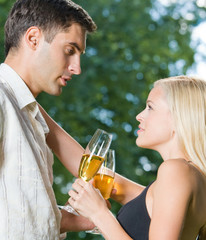 Young happy couple with champagne, outdoor