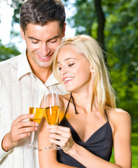 Young happy couple with champagne, outdoor