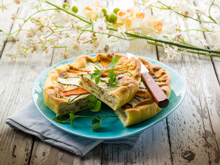 vegetables cake over dish on wood background