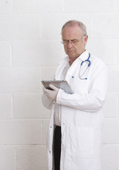 Mature Doctor with his tablet pc