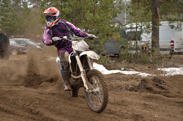 Biker leaves the track with a large plume of sand
