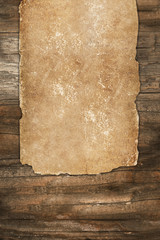 Weathered paper roll on a wooden background