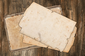 Vintage torn papers on wood