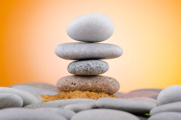 Balanced pebbles with colour background