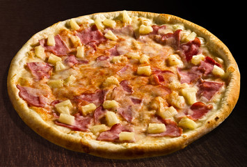 Pizza Hawaii with ham, corn and pineapple - isolated