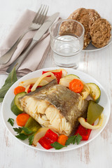 boiled fish with vegetables on the plate