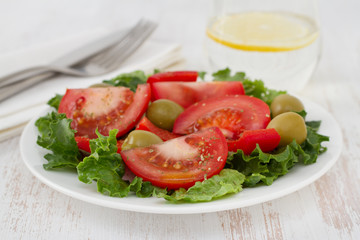 vegetable salad with olives on the plate